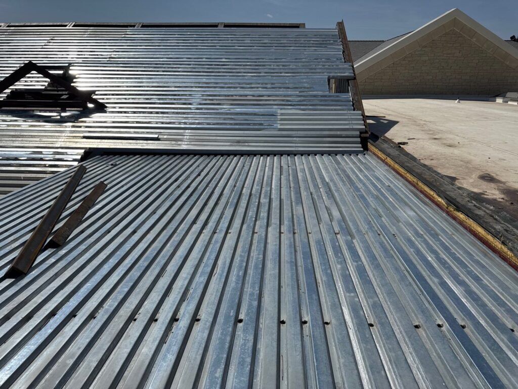 Thick-gauge metal decking on a low slope commercial roof.