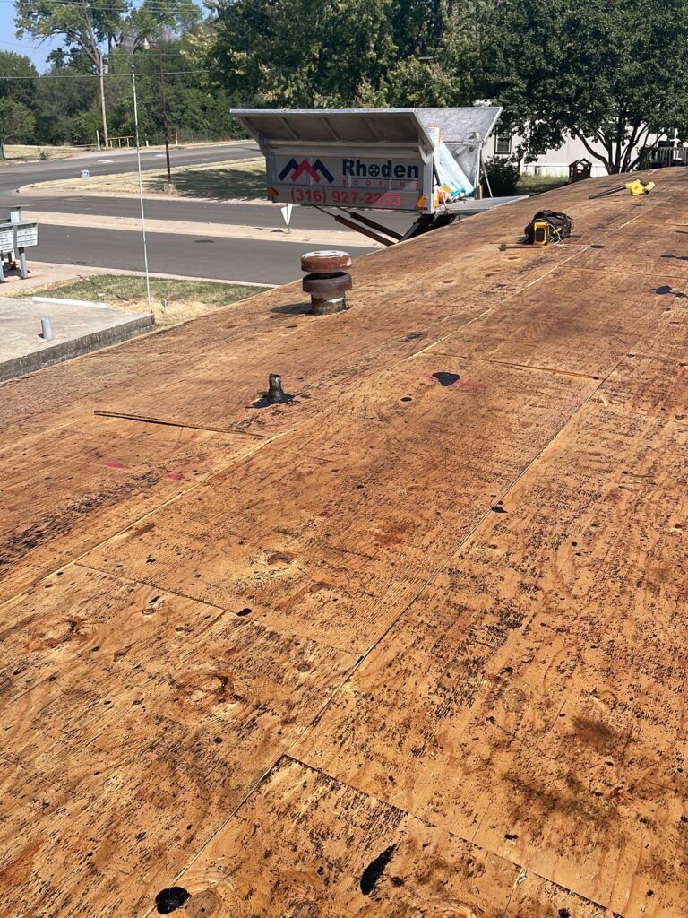 Plywood decking on a lop slope roof that has experienced buckling.