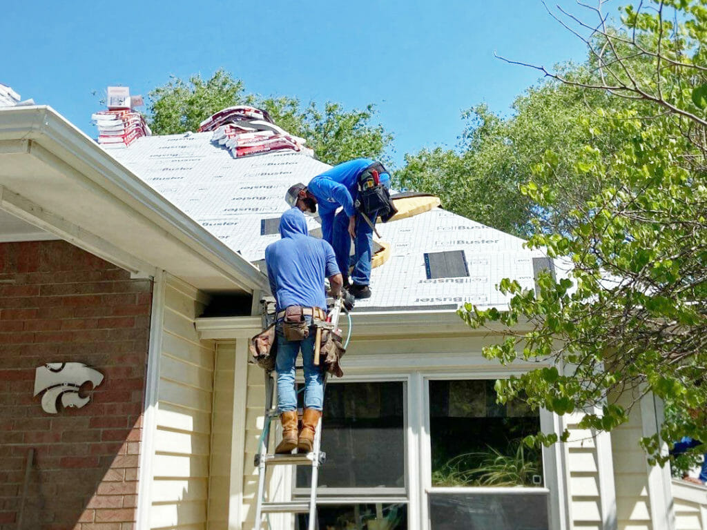 Two people installing roof Kansas