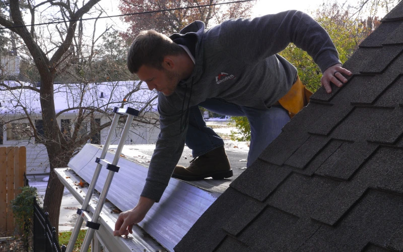 Roofing professional chalking a roof for homeowner insurance claim.