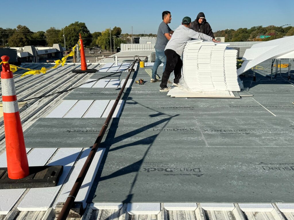 Layers of a flute fill retrofit over commercial metal roofing - Rhoden Roofing
