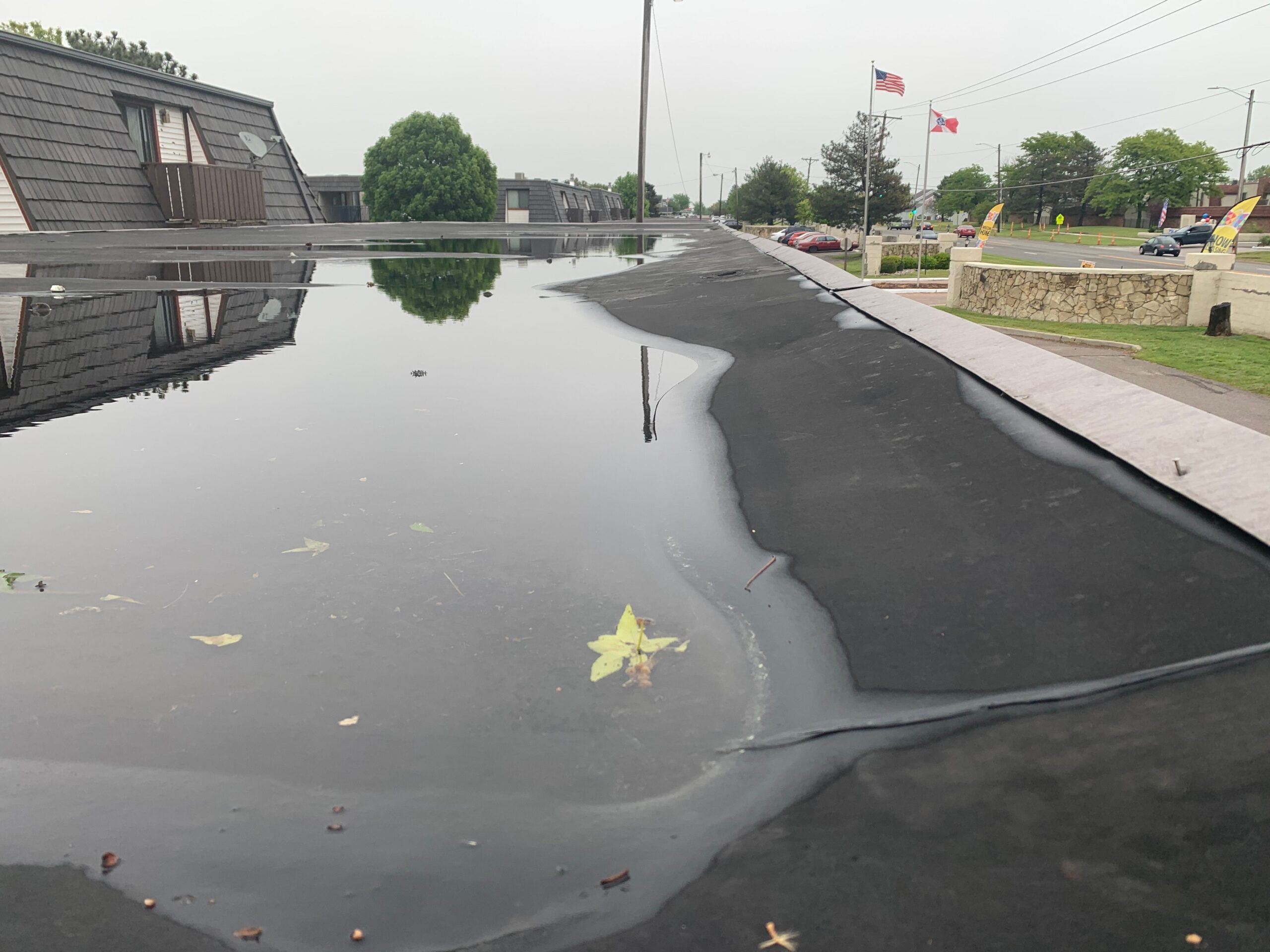 Severe, critical ponding caused by negative slope on an EPDM commercial roof.