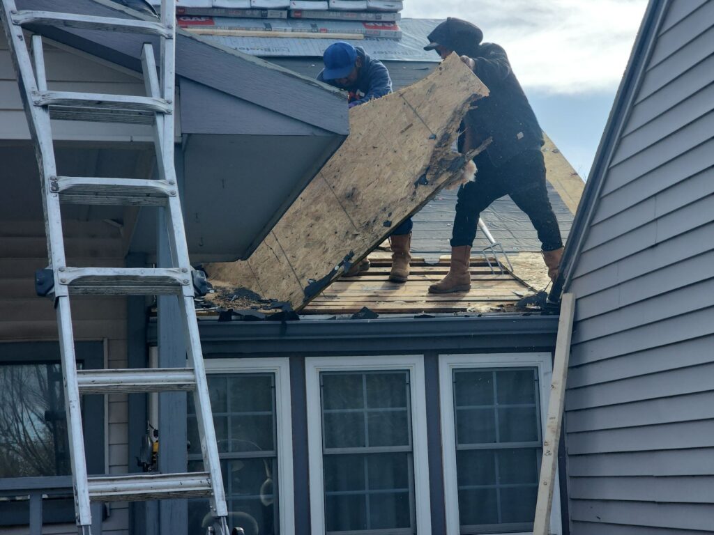 Rotted, unnailable OSB roof decking removed by roofers during a roof replacement.