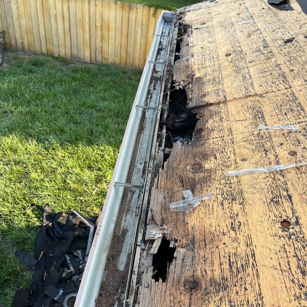 A stripped roof during a roof replacement that revealed rotted plywood decking at the eaves from ice dams.