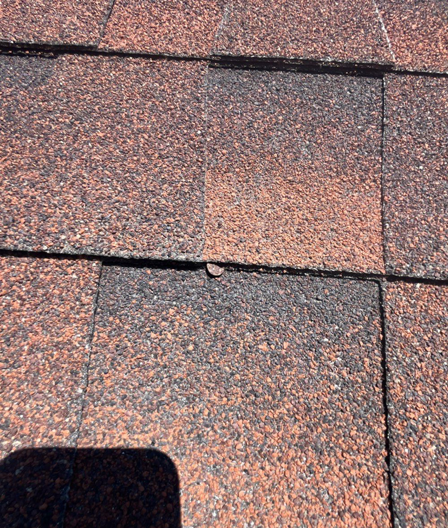 Small Exposed Nail Head on Shingle Roof With Hail Damage Granule Loss