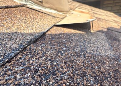 Warped heater flue base flashing causes fasteners to pull out.
