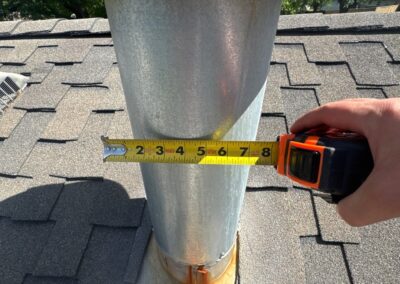 Rust at the heater flue cap and base. No storm collar.