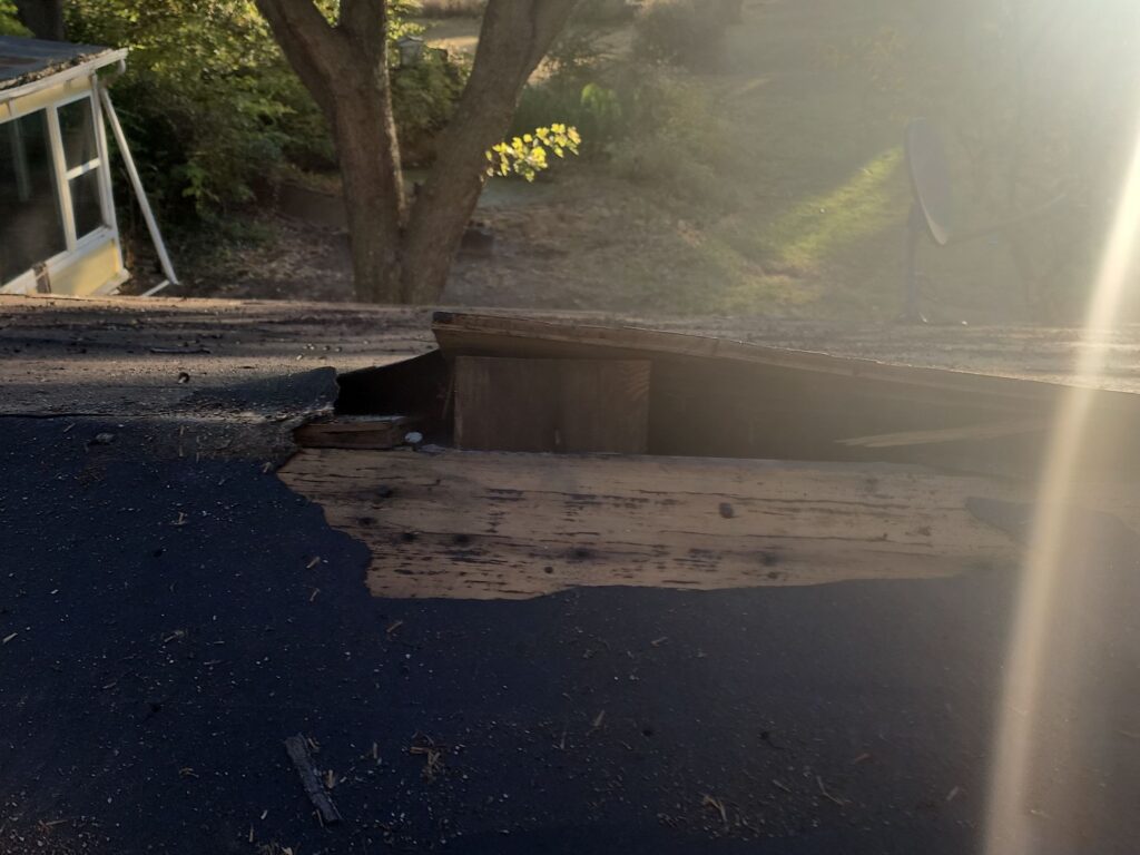 Buckling at the eaves of a house, resulting in critical roof failure.