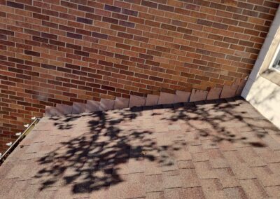 Counterflashing can be cut in to the rake wall on brick homes to prevent water from seeping through the mortar or under the shingles.