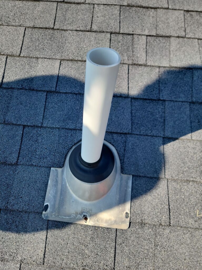 Healthy rubber pipe boot with degraded sealant on fasteners.
