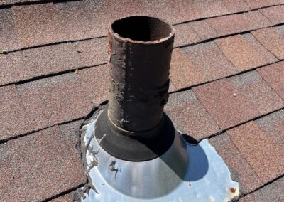 Rubber pipe boot with previous attempts to repair visible.