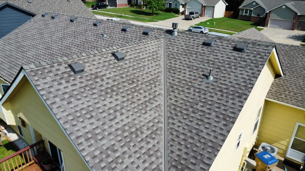 An asphalt shingle roof that retained box vents when the roof was replaced due to its complex, enclosed attic structure.