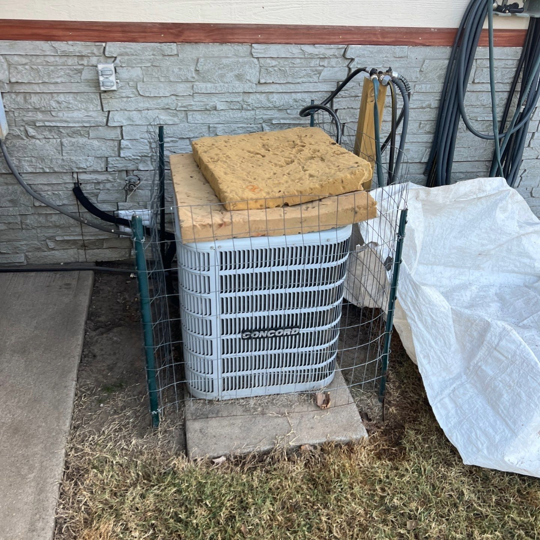 Air conditioner protected with OSB and foam insulation during a roof replacement.