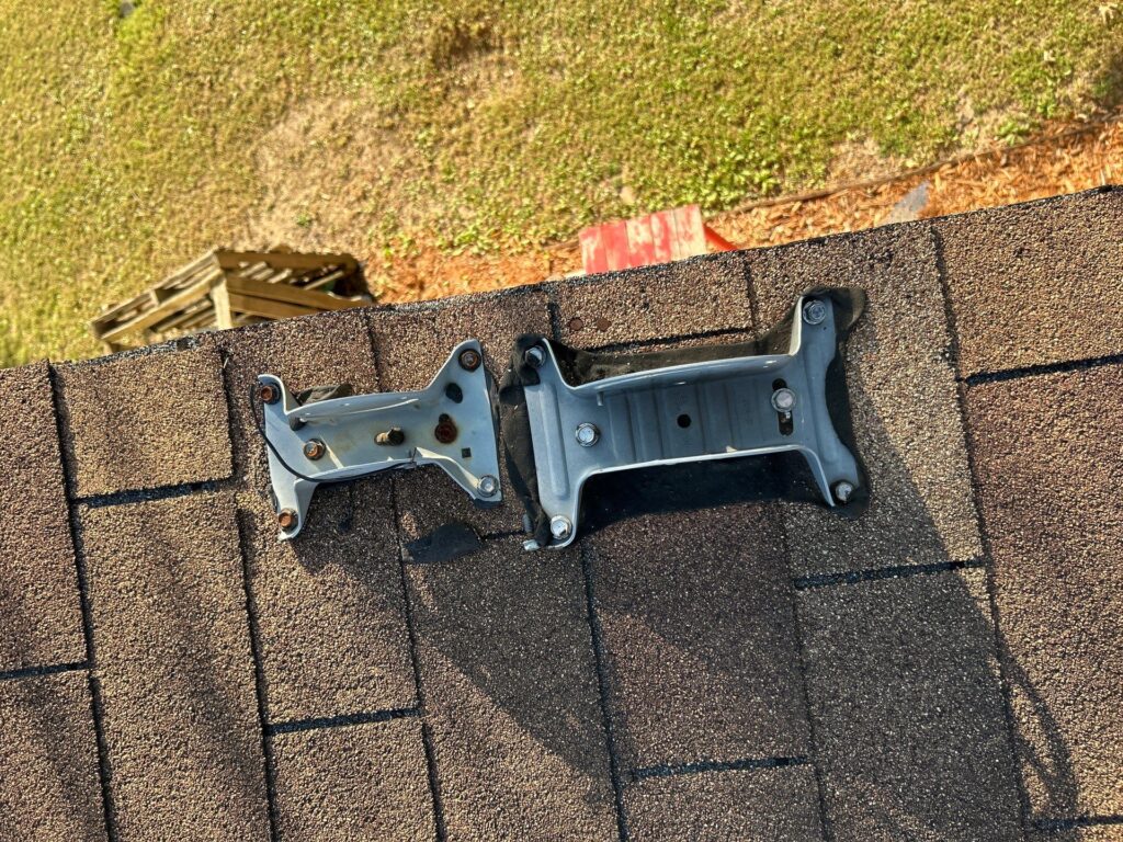 Footplates for roof-mounted satellite dishes on an asphalt shingle roof.