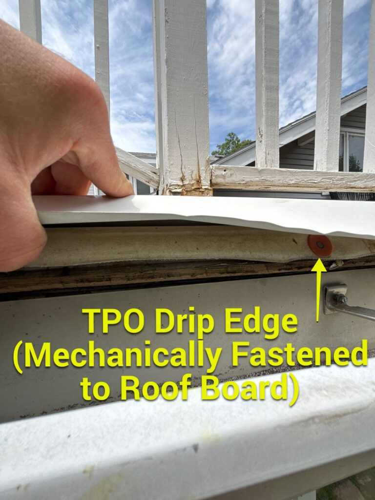 An annotated photo of a small drip edge mechanically fastened to the roof deck at the perimeter of a residential balcony structure.