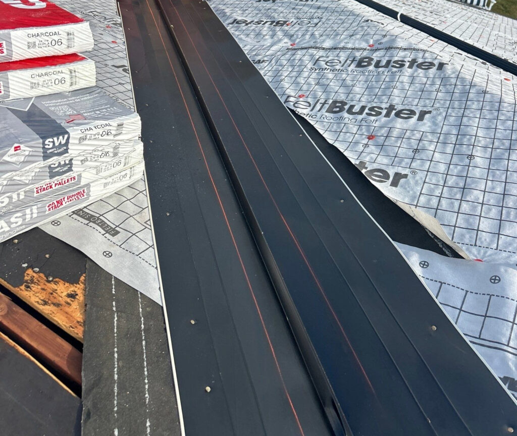 Valley metal installed on underlayment during an asphalt shingle roof replacement.