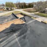 Poor base securement caused severe wind uplift on an EPDM membrane on a low-slope commercial roof.