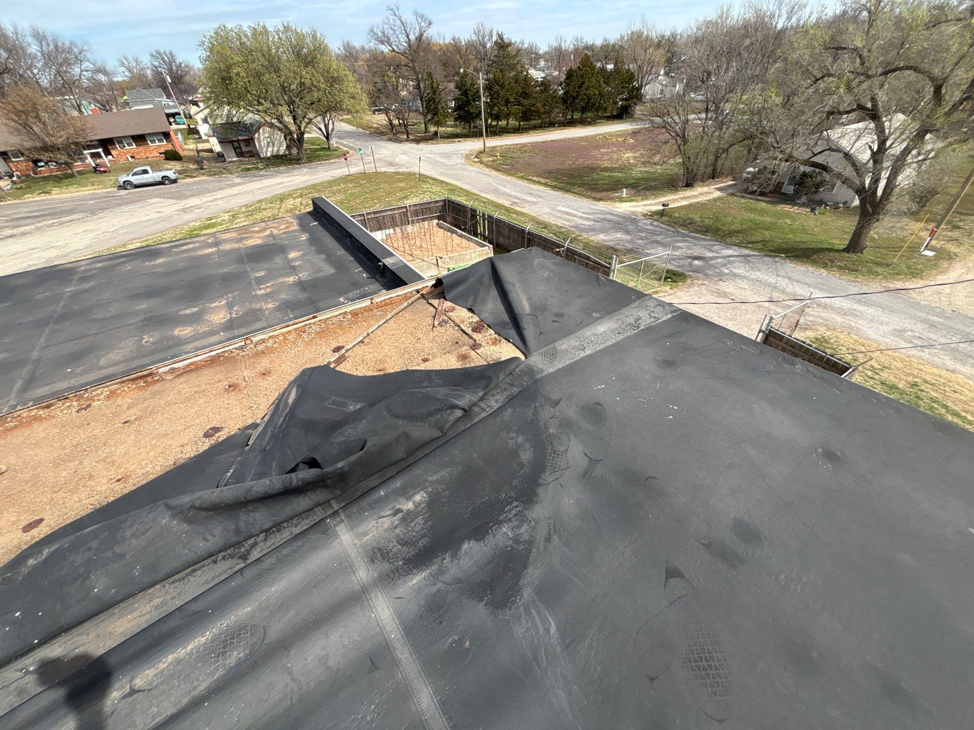 Poor base securement caused severe wind uplift on an EPDM membrane on a low-slope commercial roof.