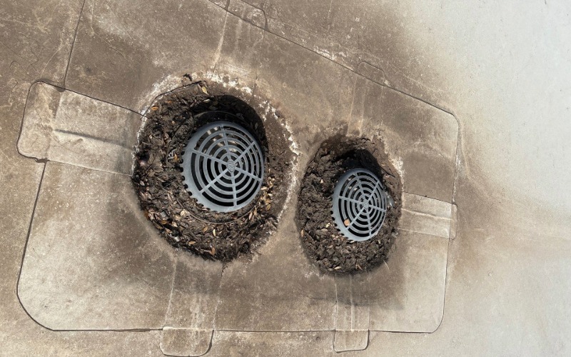 Two clogged internal drains on a low slope TPO commercial roof have reduced possible drainage area.