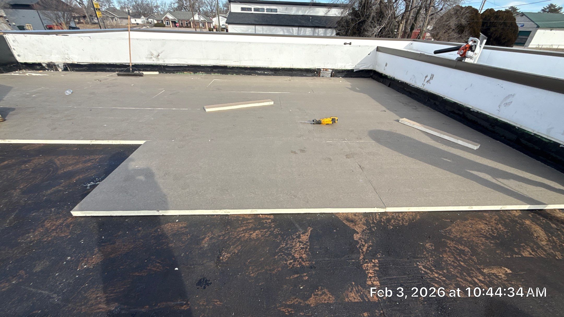 PolyIso insulation on the wood roof deck of a low-slope commercial building.