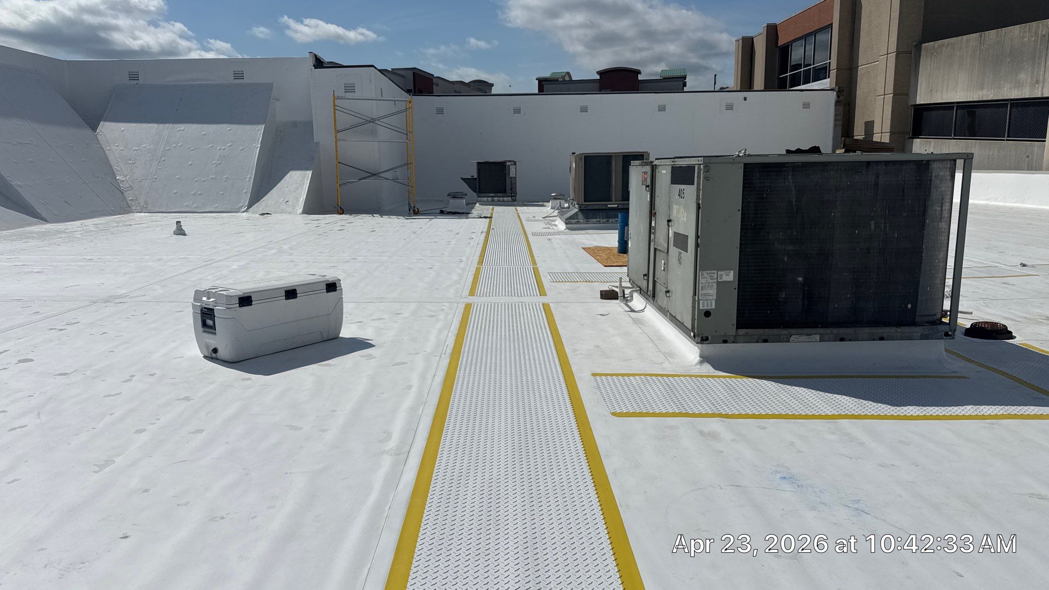 Walkway Pads on Branson Landing Walkway pads with yellow visibility lining on the outside and white TPO on the roof surface.
