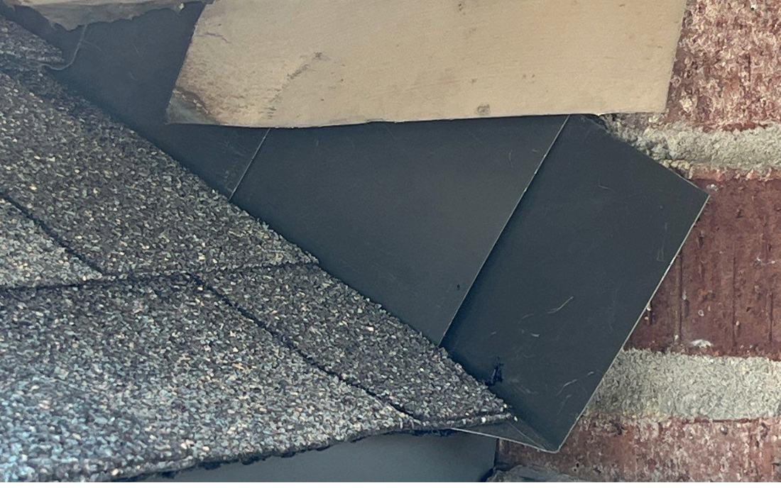 Kickout Flashing at a Sidewall A brick sidewall with step flashing and kickout flashing to direct water into the gutters below.