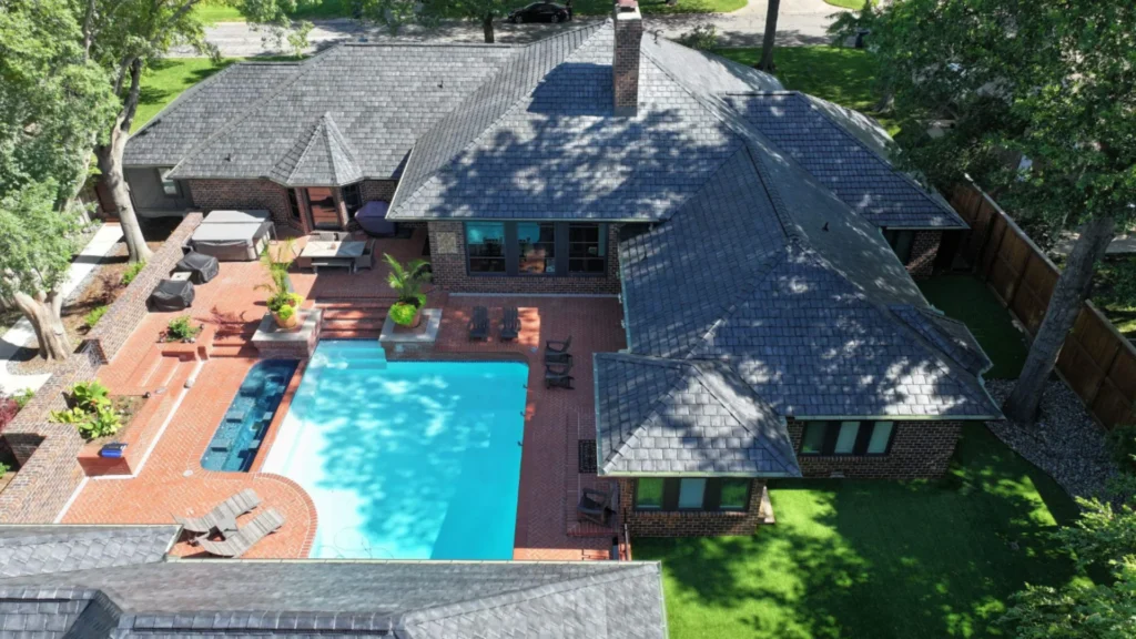 A Brava slate roof on a single-story property with a pool between the dwelling and pool house.