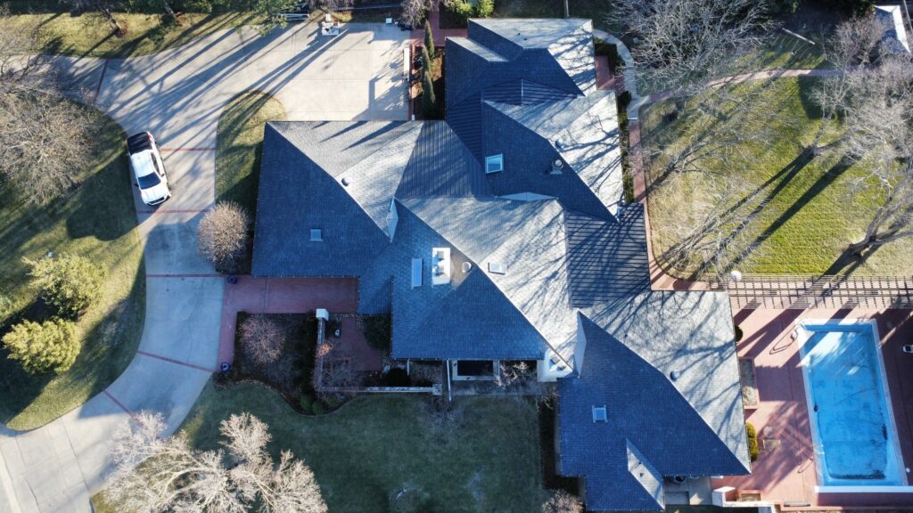 A Brava tile roof with metal accents and multiple hips.