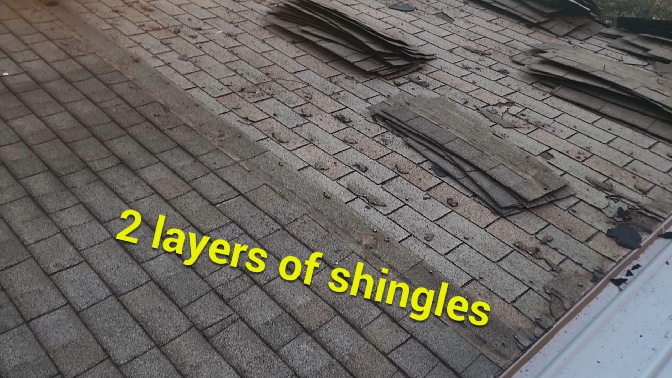 Two Layers of Asphalt Shingles Two layers of asphalt shingles found during tear-off of a roof system, annotated.